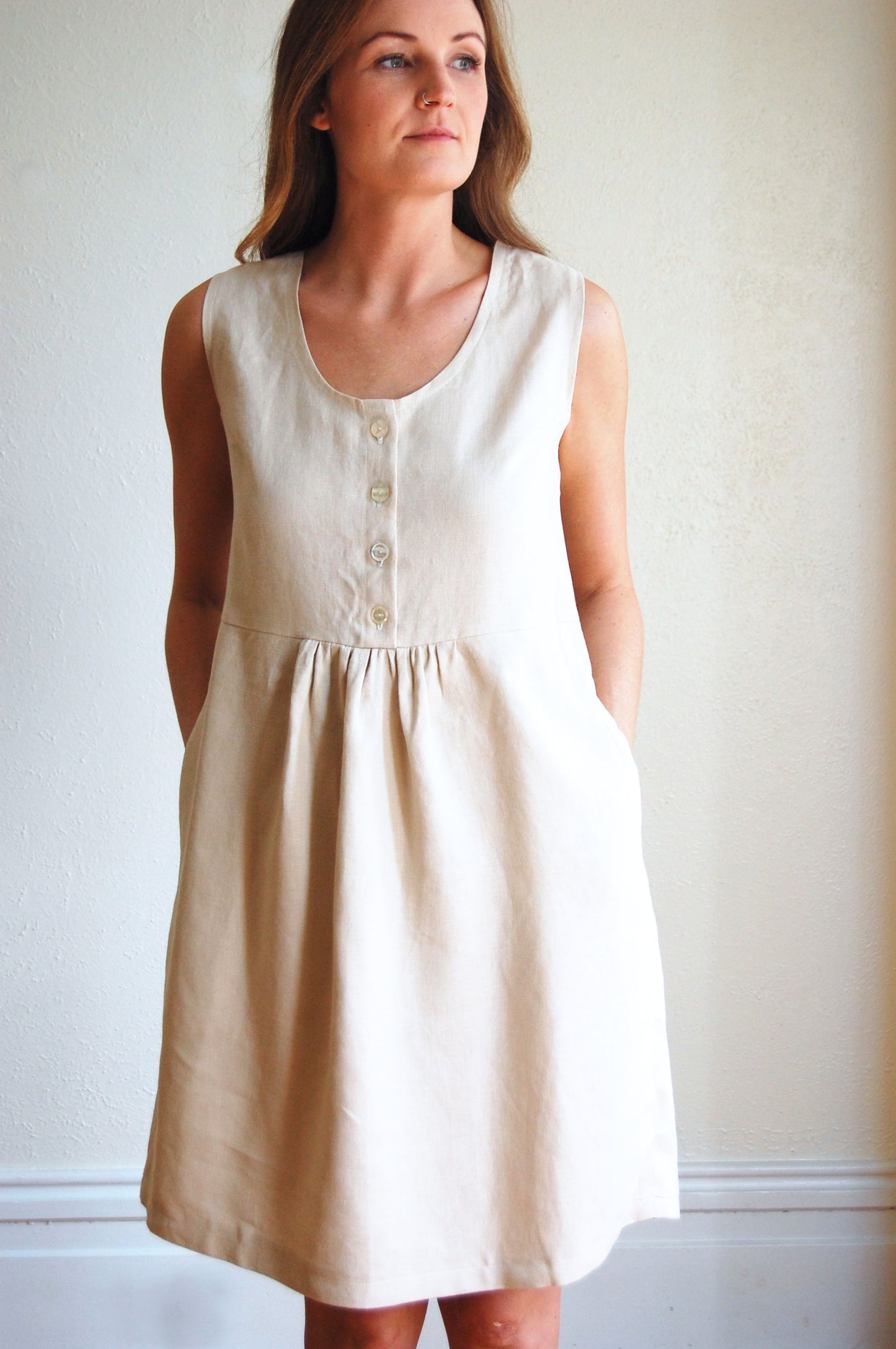 natural linen dress with gathered waist, button front, sleeveless and knee length